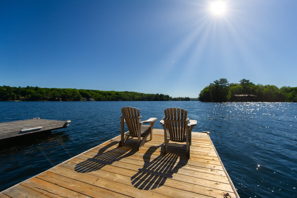 Sunrise on two empty Adirondack chairs